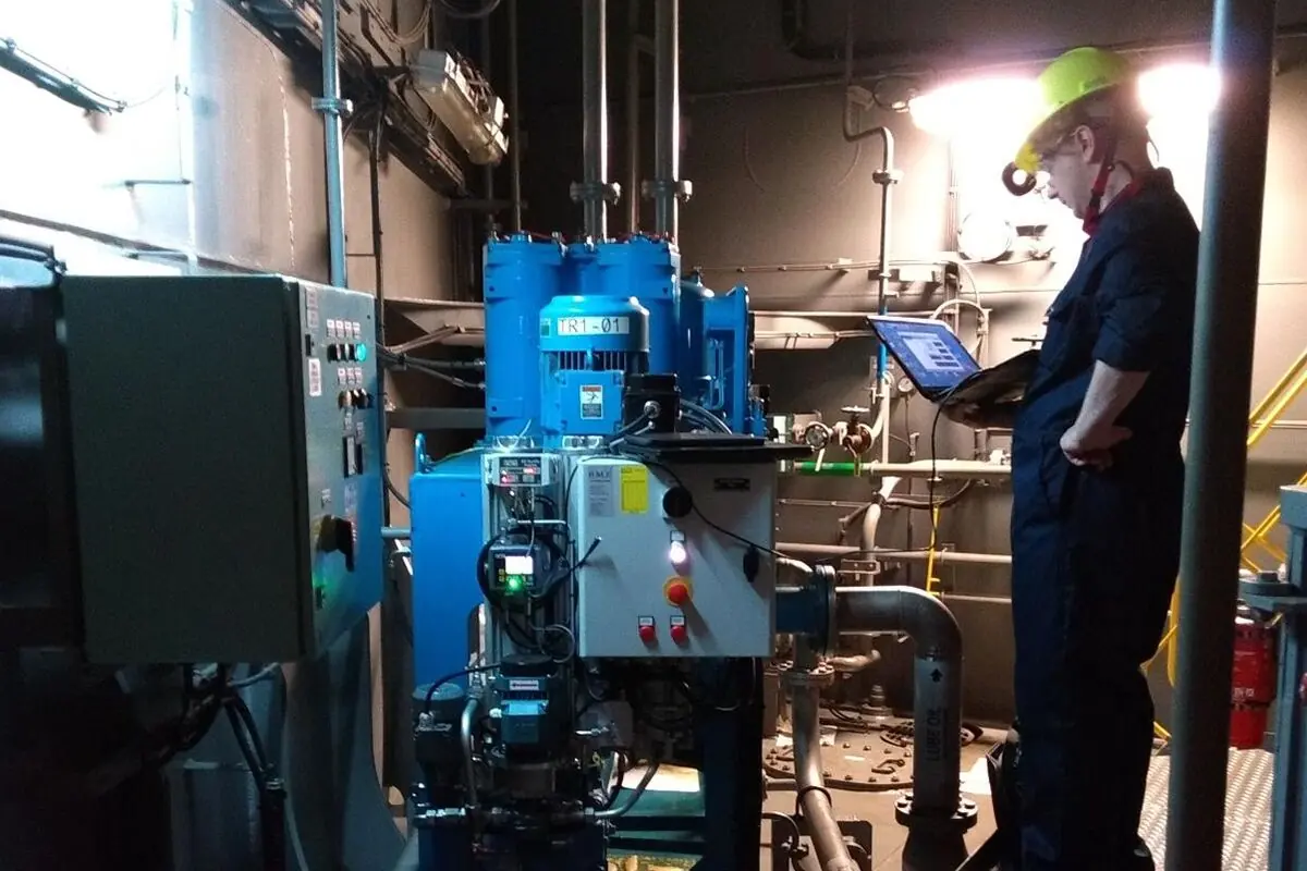 Engineer monitoring a fluid conditioning system